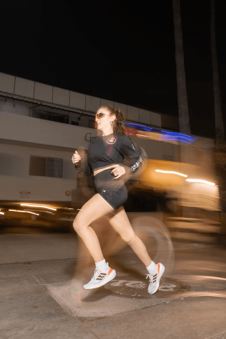 Runner moving through a night street